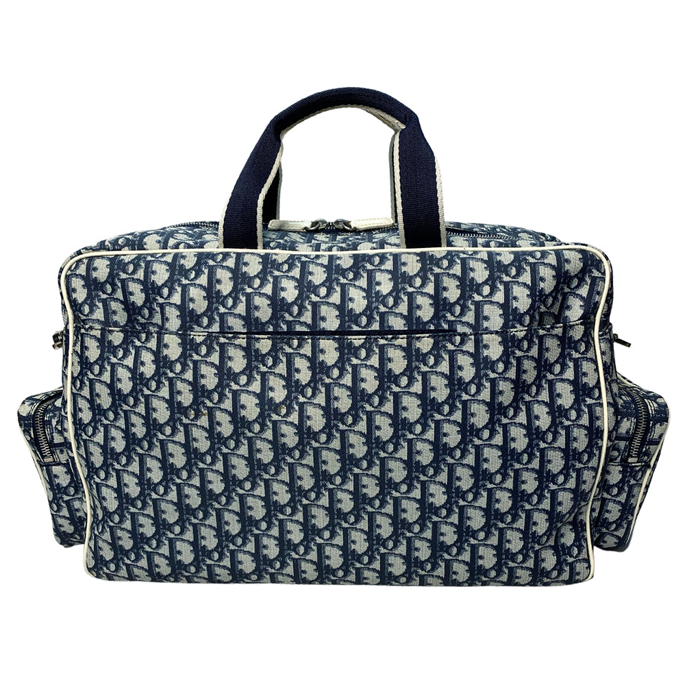 John Galliano for Dior, 2002 navy monogram canvas large weekender bag with 2 outer zip end pouches, velcro rear pocket, white patent leather piping, zipper pulls, No 1 appliqué in front and 2 accent stripes in front. Double canvas handles, detachable, adjustable navy carry strap. Silver-tone zipper and hardware, navy nylon lining with zippered pocket, two snap slip pockets, 3 open pouch pockets. Made in Italy
