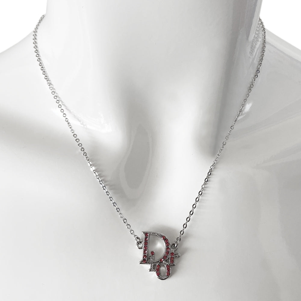 Christian Dior pink crystal embellished Dior Logo necklace with silver-tone chain attached to crystal embellished Dior logo charm with lobster back closure and tiny Dior engraved hanging logo D charm in back