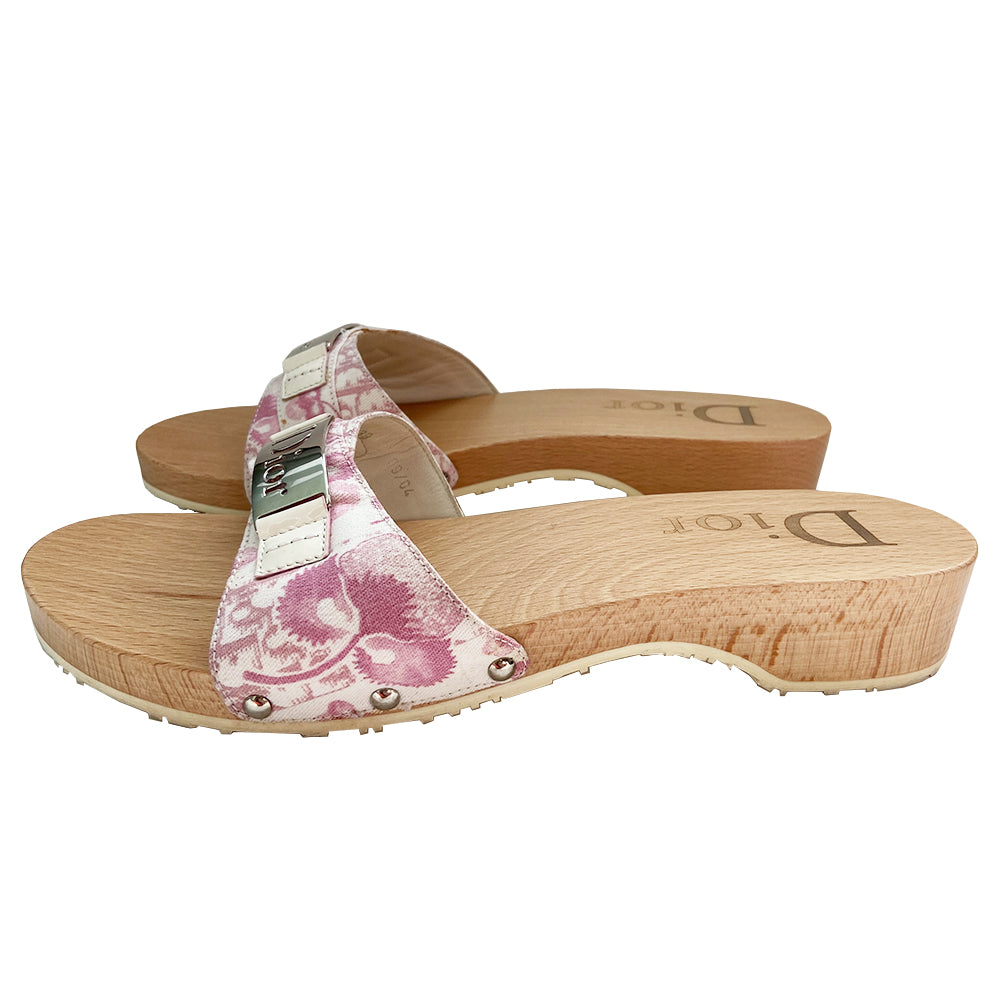 Christian Dior Girly Diorissimo floral slide Sandals, 2004 by John Galliano for Christian Dior. Pink and creme Diorissimo printed canvas upper features silver-tone cutout Dior logo plate, ivory patent and silver-tone side studs. Dior logo stamped into wood sole with white rubber bottom DIOR logo stamped lower soles.