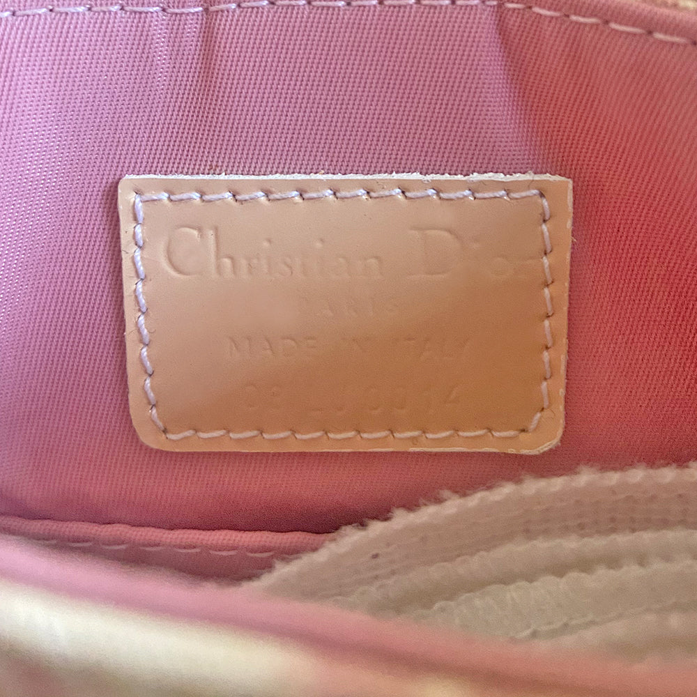 Christian Dior Girly pink monogram cross body reporter bag by John Galliano for Dior 2004 with pearl center white flowers, white piping, Swarovski crystal No 1 & Dior logo. Pink satin webbing adjustable shoulder strap with silver-tone Dior engraved sliders. Pink textile interior, one inner pocket. Made in Italy