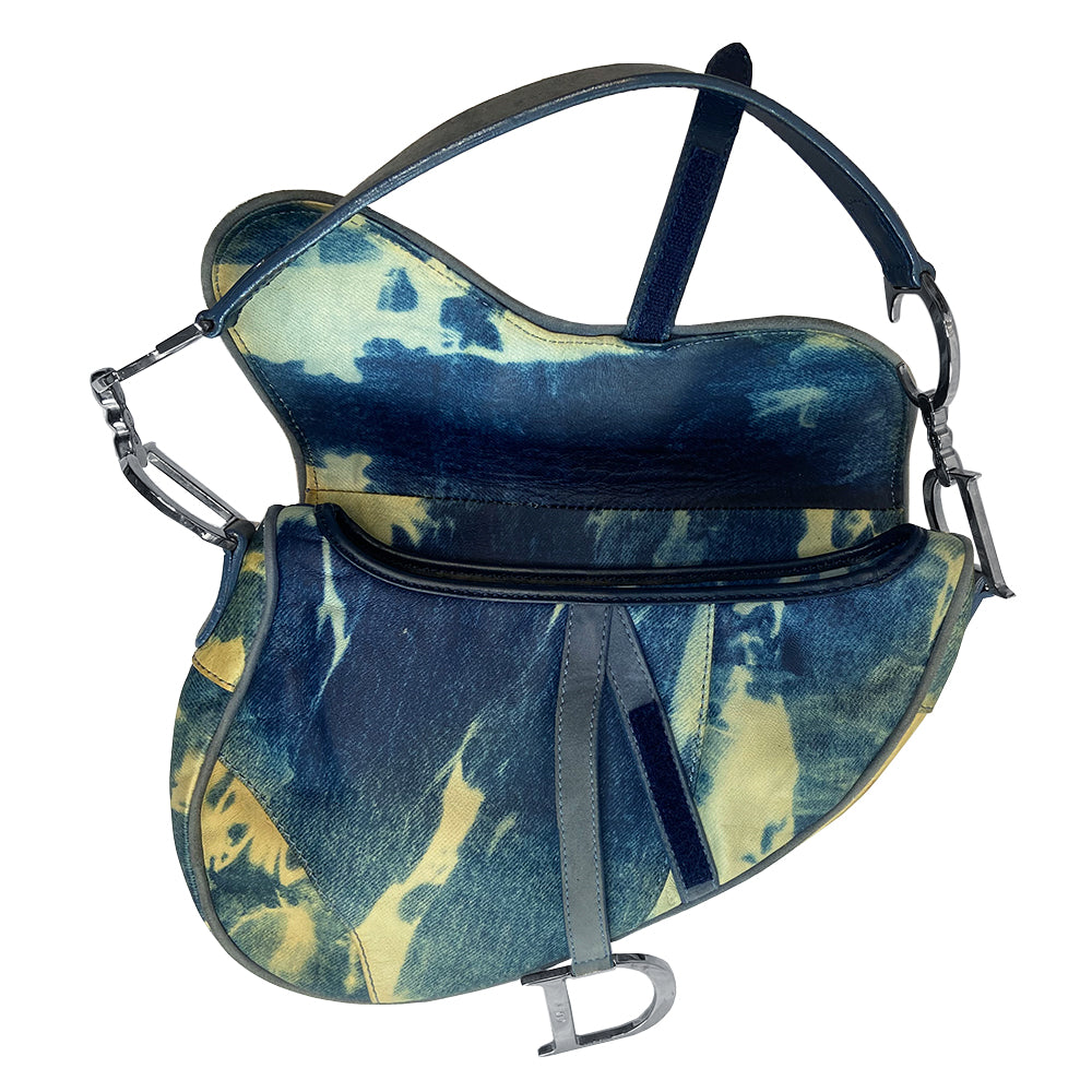 Christian Dior blue and yellow tie dye leather saddle bag by John Galliano for Dior, 2000 with silver tone hardware, single rear slip pocket, velcro front closure. Interior blue and white tie dye lining with single zip pocket. Made in Italy