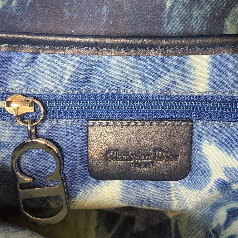 Christian Dior blue and yellow tie dye leather saddle bag by John Galliano for Dior, 2000 with silver tone hardware, single rear slip pocket, velcro front closure. Interior blue and white tie dye lining with single zip pocket. Made in Italy