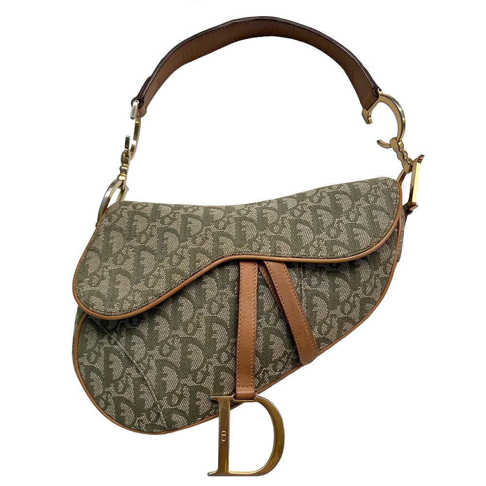 Christian Dior green diorissimo monogram canvas saddle bag, John Galliano for Dior 2001 with gold-tone hardware, caramel leather. Single flat top leather handle featuring CD side logos. Velcro front closure at flap with front gold D logo. Rear slip snap pocket. Interior tonal nylon lining with single zip pocket.