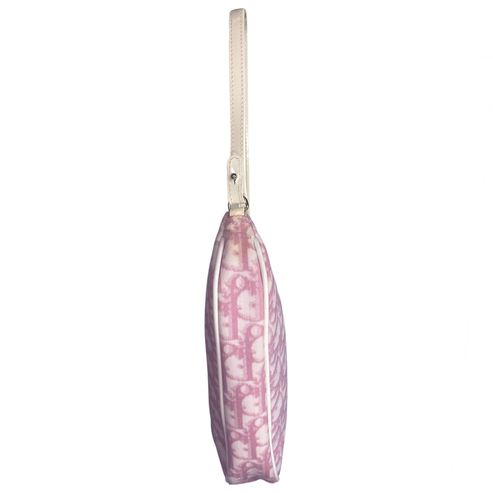 Christian Dior pink canvas monogram mini saddle pochette by John Galliano for Dior 2004 with white patent leather piping and strap, silver-tone hardware. Leather strap unclips at one end and can be looped to carry wristlet style. Top zipper closure with pink textile interior. Duster and card included. Made in Spain