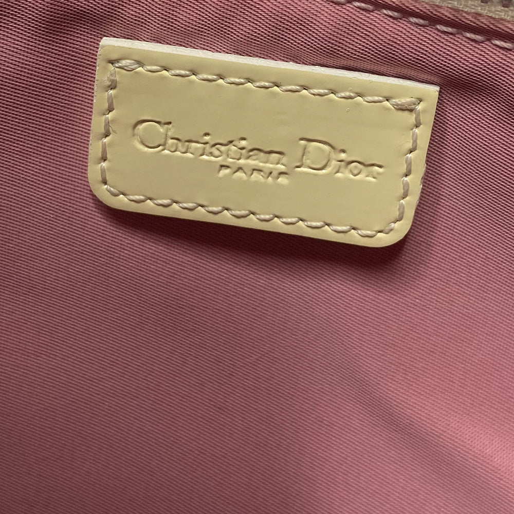 Christian Dior pink canvas monogram mini saddle pochette by John Galliano for Dior 2004 with white patent leather piping and strap, silver-tone hardware. Leather strap unclips at one end and can be looped to carry wristlet style. Top zipper closure with pink textile interior. Duster and card included. Made in Spain