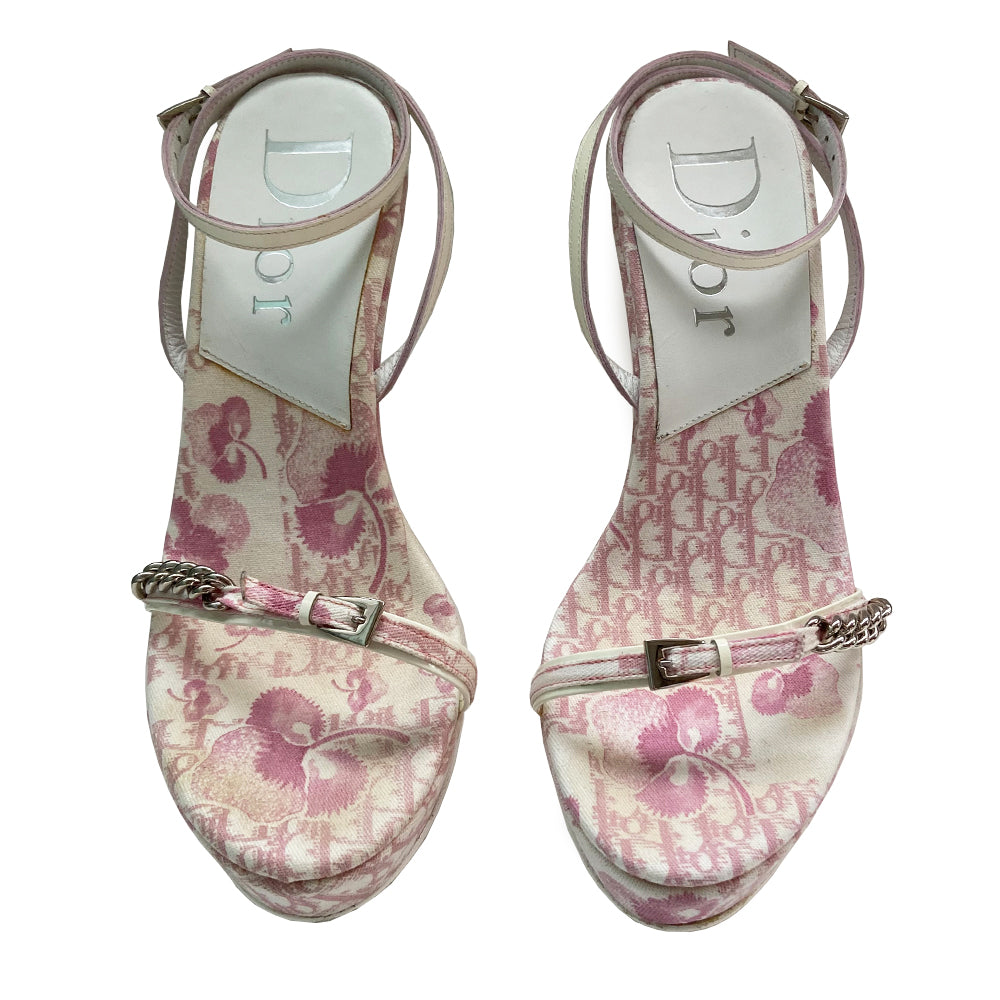 Christian Dior pink cherry blossom monogram on white open toe sandals from John Galliano spring 2003 featuring pink floral monogram with cherry blossom canvas soles, white patent leather heels and wrap around ankle straps. Silver chain and buckle detail layered on upper monogram strap edged with patent leather. Made in Italy