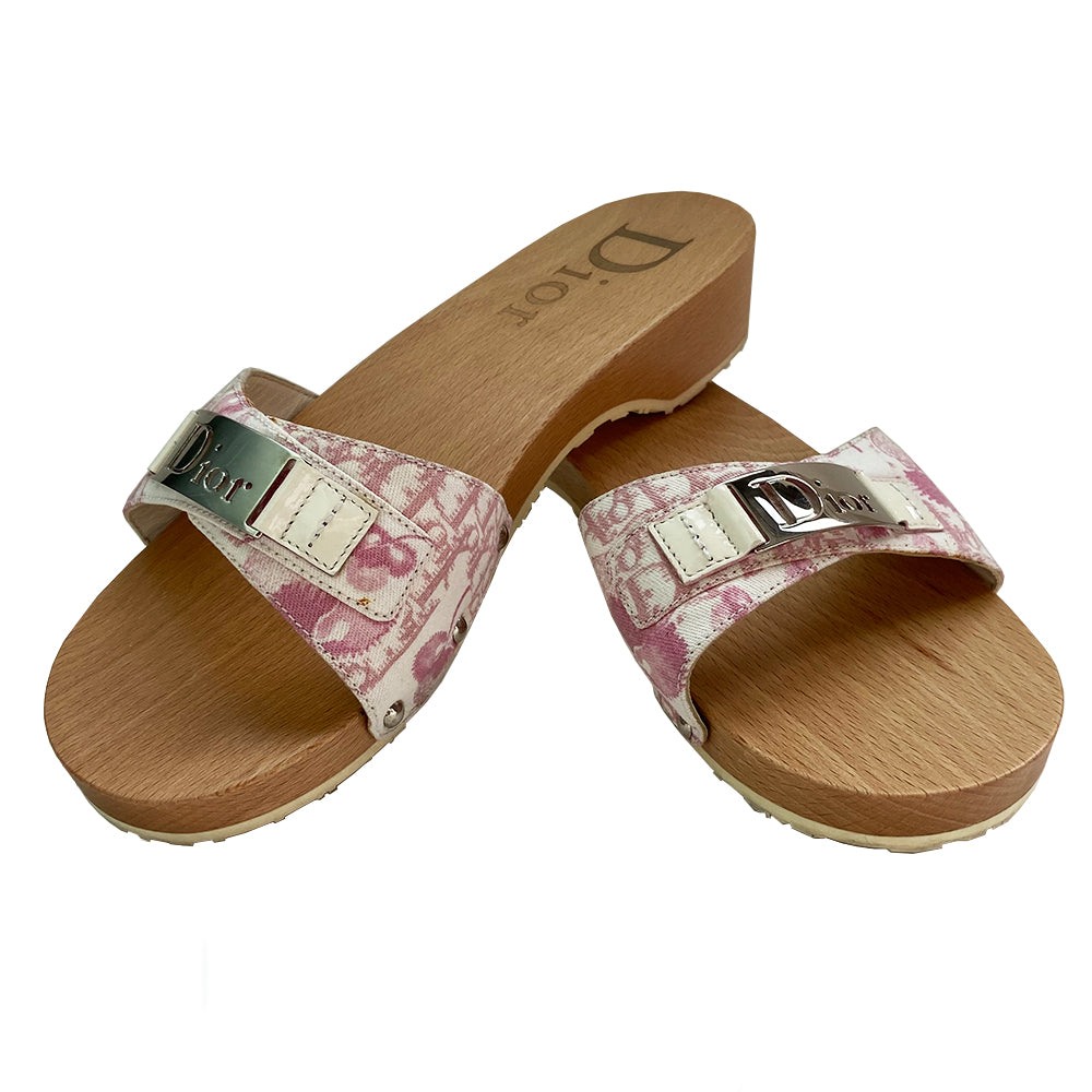 Christian Dior Girly Diorissimo floral slides Sandals, 2004 by John Galliano for Christian Dior. Pink and creme Diorissimo printed canvas upper features silver-tone cutout Dior logo plate, ivory patent and silver-tone side studs. Dior logo stamped into wood sole with white rubber bottom DIOR logo stamped lower soles.