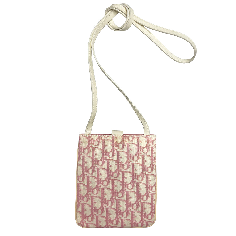 Christian Dior Girly pink monogram cross body reporter bag by John Galliano for Dior 2004 with pearl center white flowers, white piping, Swarovski crystal No 1 & Dior logo. Pink satin webbing adjustable shoulder strap with silver-tone Dior engraved sliders. Pink textile interior, one inner pocket. Made in Italy