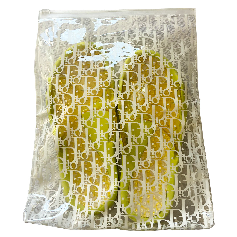 Christian Dior lime green and yellow monogram jelly pool slides, John Galliano era. Clear yellow upper with embossed Dior logo, perforated air holes, silver-tone Dior logo stud attachments at sides, monogram insole with clear nubby overlay for extra comfort. Rubber sole with grippy nubs and Dior logo imprint. Made in Italy