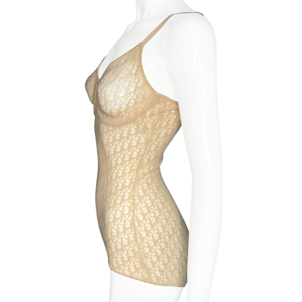 Neutral tone Christian Dior Monogram slip-on stretch bodysuit circa 1990s with low back, adjustable elastic straps, underwire at bust, hooks at crotch. Made in USA