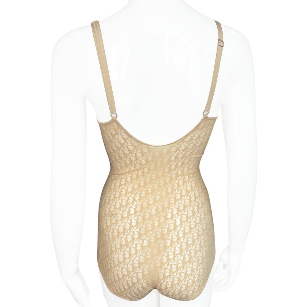 Neutral tone Christian Dior Monogram slip-on stretch bodysuit circa 1990s with low back, adjustable elastic straps, underwire at bust, hooks at crotch. Made in USA