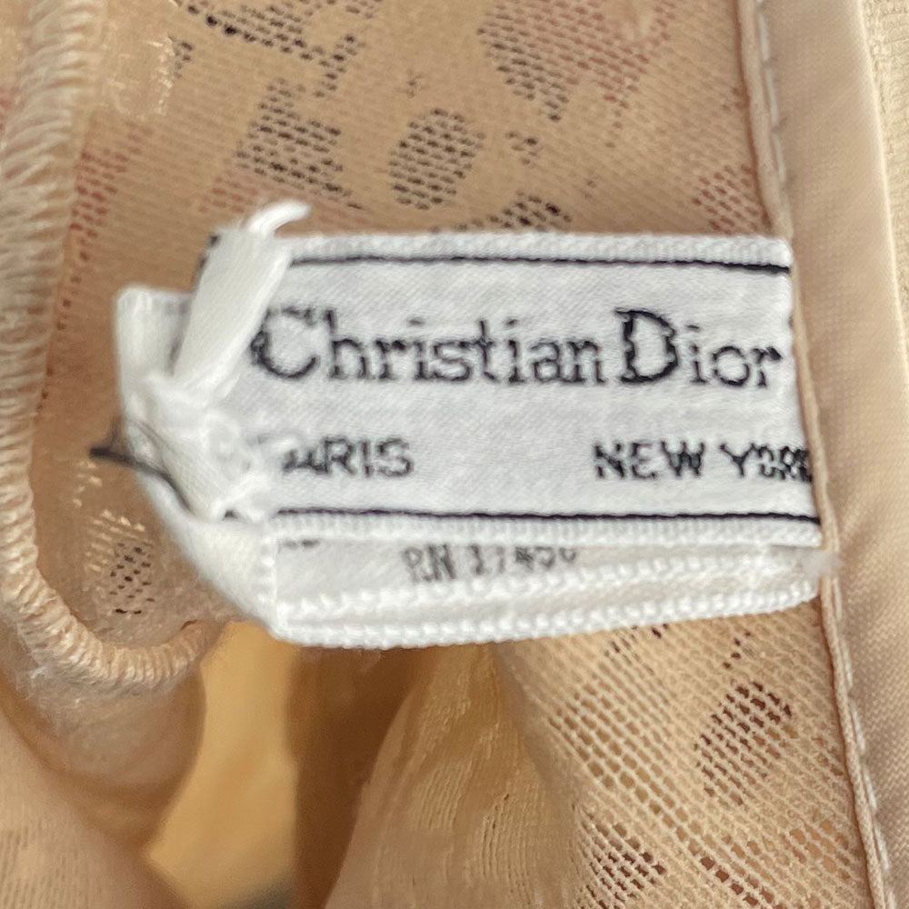 Neutral tone Christian Dior Monogram slip-on stretch bodysuit circa 1990s with low back, adjustable elastic straps, underwire at bust, hooks at crotch. Made in USA