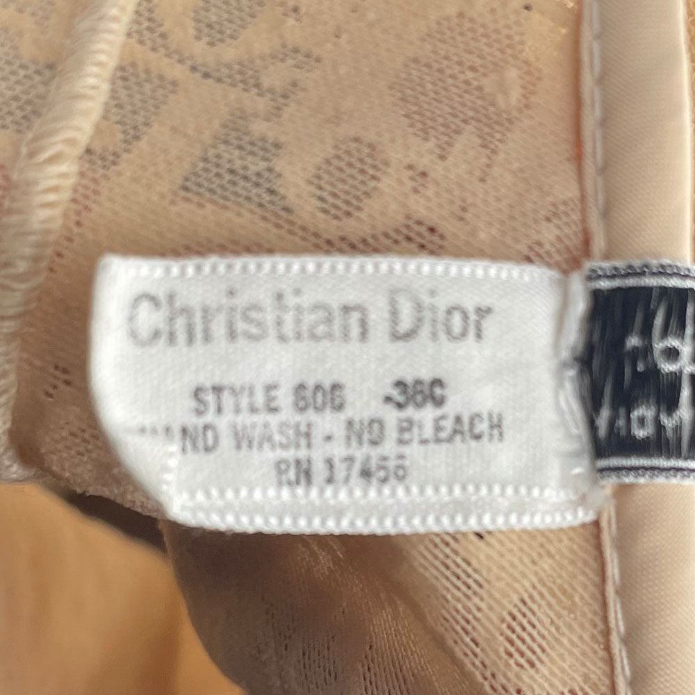 Neutral tone Christian Dior Monogram slip-on stretch bodysuit circa 1990s with low back, adjustable elastic straps, underwire at bust, hooks at crotch. Made in USA