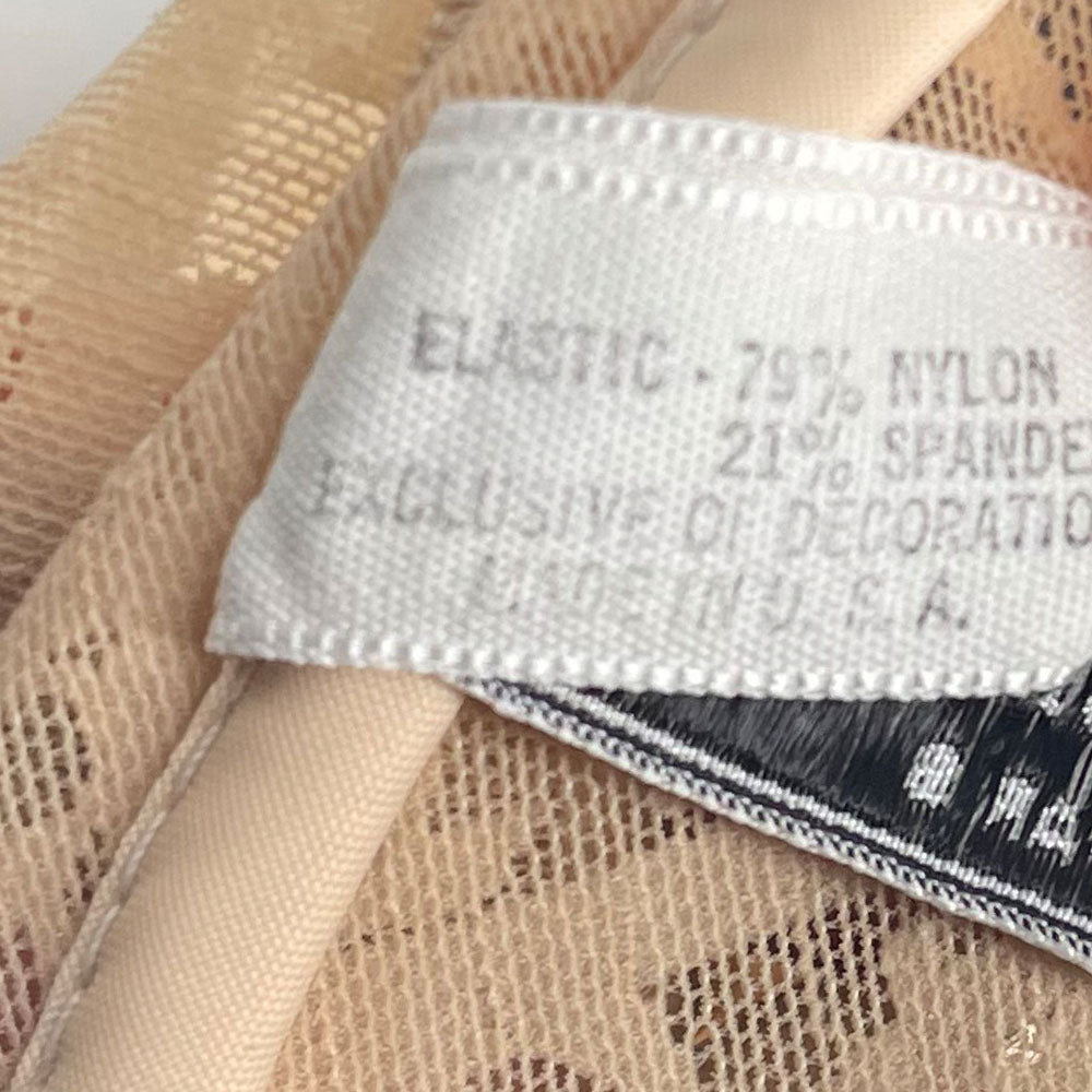 Neutral tone Christian Dior Monogram slip-on stretch bodysuit circa 1990s with low back, adjustable elastic straps, underwire at bust, hooks at crotch. Made in USA