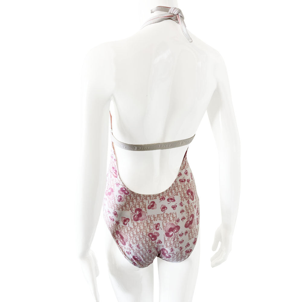 Christian Dior cherry blossom one-piece swimsuit by John Galliano for Dior from 2004 Logo Flowers Collection. Halter style tie neck, deep V neckline and low back. Solid pink upper and cherry blossom monogram lower divided by Dior Logo wide elastic under the bust line and across the back. Size: FR 40. Made in Italy
