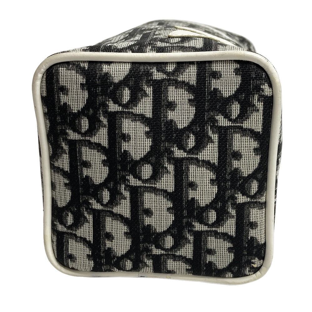 Christian Dior monogram mini vanity case by John Galliano for Dior, 2006. Black and grey monogram canvas rectangular cylinder with white patent piping, No 2 appliqué and top handle. Wrap around silver-tone top zipper closure, black textile interior. Made in Spain