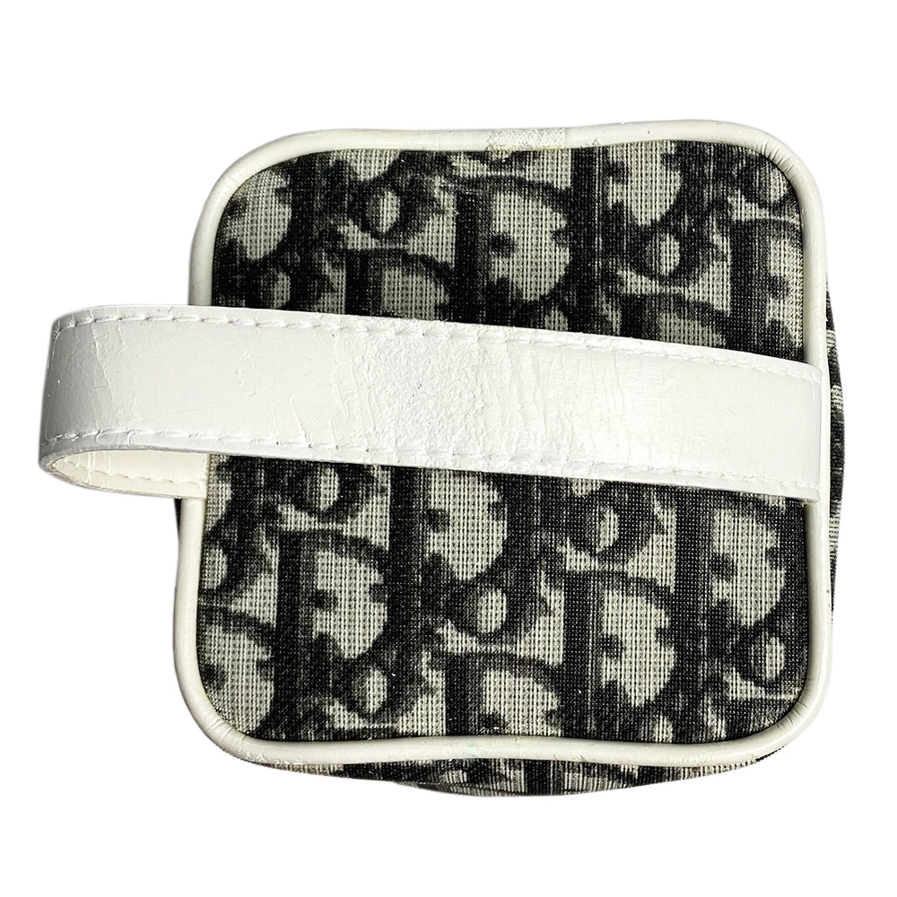 Christian Dior monogram mini vanity case by John Galliano for Dior, 2006. Black and grey monogram canvas rectangular cylinder with white patent piping, No 2 appliqué and top handle. Wrap around silver-tone top zipper closure, black textile interior. Made in Spain