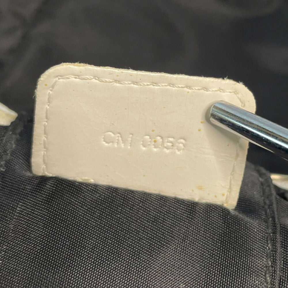 Christian Dior canvas black and grey monogram top handle mini rectangular cylinder bag by John Galliano for Dior, 2003 with white patent piping, top handle and leather No 2 appliqué. Wrap around silver-tone top zipper closure opens to black textile interior. Made in Spain