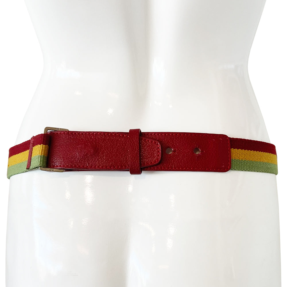 Christian Dior Rasta mini saddle belt waist bag by John Galliano for Dior 2004. Diorissimo canvas with red leather outer piping, yellow & green accent piping, silver-tone hardware. Adjustable canvas webbing & leather belt with 5 hole pin closure. Top flap magnetic snap closure with green & yellow leather straps, CD engraved hanging D, brown satin textile interior.