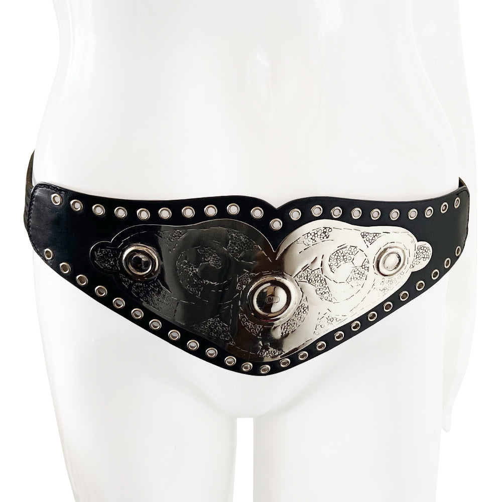 Christian Dior Championship Belt from fall 2001 RTW runway collection by John Galliano. Black leather belt with eyelets surrounding the large embossed silver-tone engraved metal plate with CD logo at center. Leather strands connect to end pieces with silver-tone CD engraved buckle with 6 adjustment holes. Made in Italy
