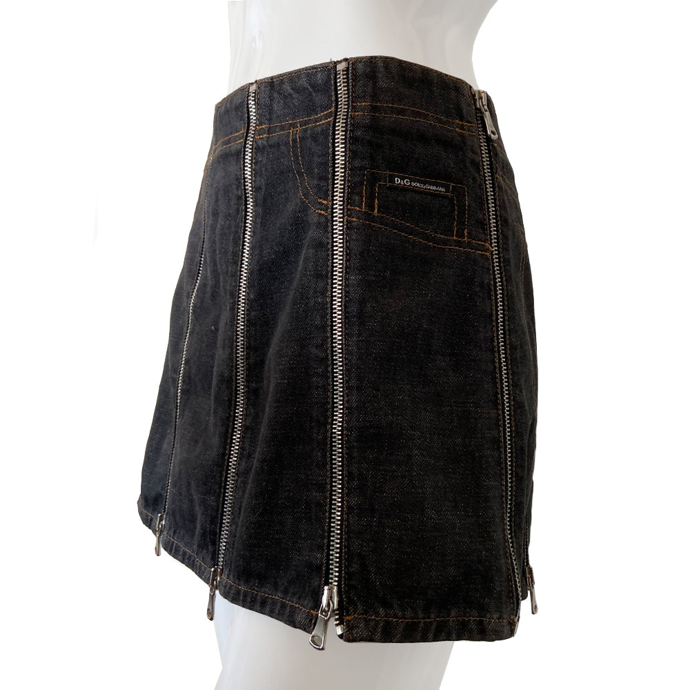 Dolce & Gabbana Zip Panel Black Denim Mini Skirt from 2004 with 10 zippered denim panels and silver-tone D&G stamped zipper pulls that unzip individually from bottom to top. Accent stitching to mimic jeans pockets in back and front. D&G tag attached to faux front pocket. Made in italy