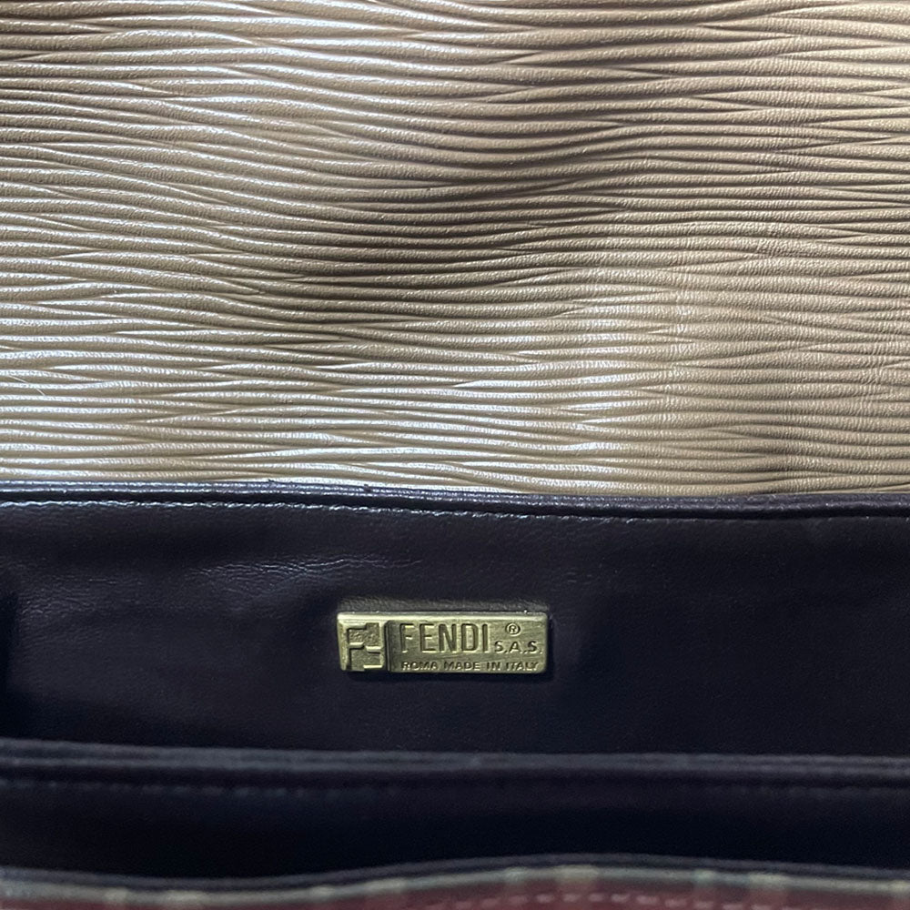 Fendi SAS circa 1970's tan and brown patent leather monogram FF Zucca print cross-body bag with front closure strap that wraps around bag and through brushed gold tone hardware. Long leather strap suitable to wear cross body, brown leather lining with three open interior sections and one zip pocket. Made in Italy
