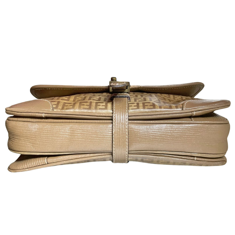 Fendi SAS circa 1970's tan and brown patent leather monogram FF Zucca print cross-body bag with front closure strap that wraps around bag and through brushed gold tone hardware. Long leather strap suitable to wear cross body, brown leather lining with three open interior sections and one zip pocket. Made in Italy
