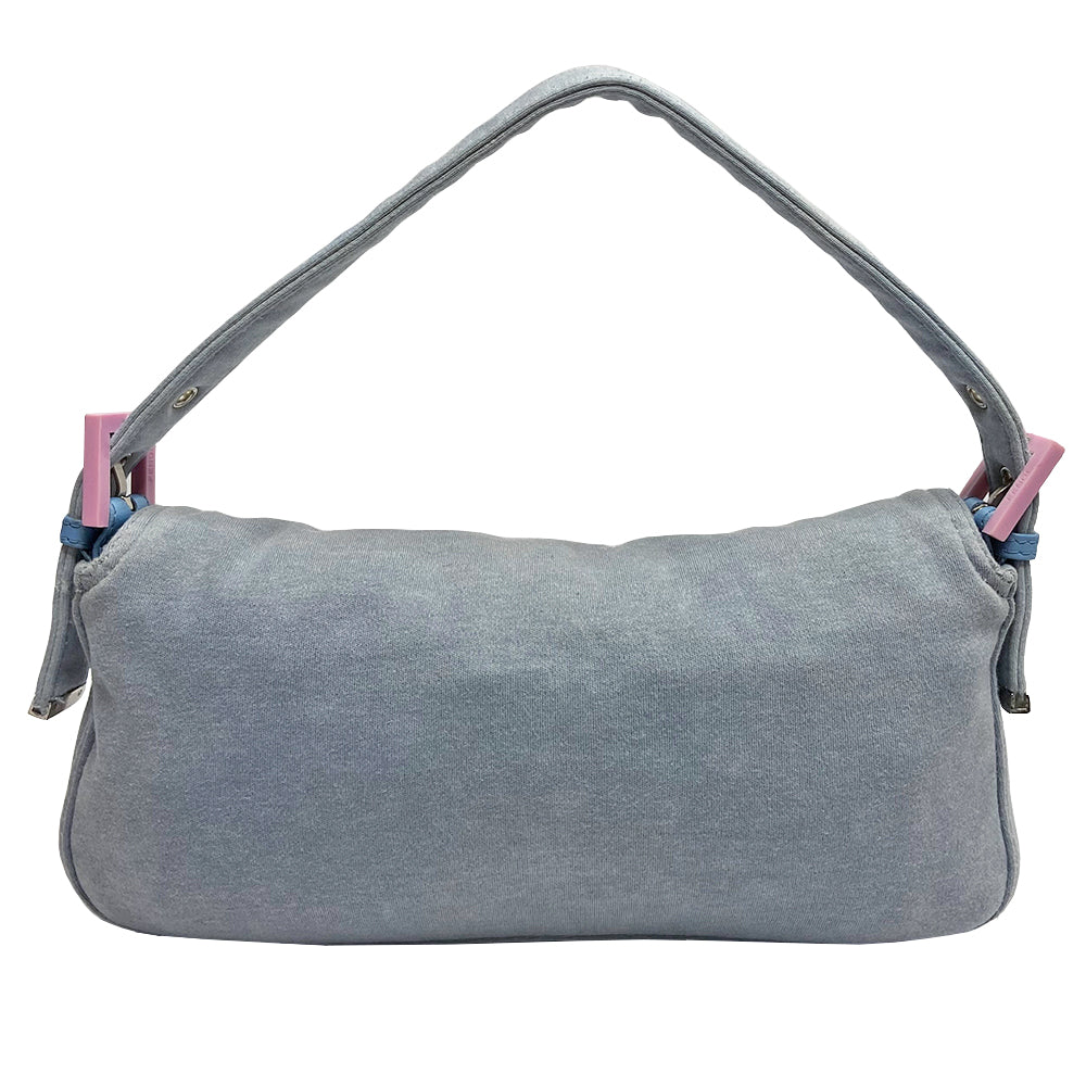 Fendi Jersey Fabric Baguette powder blue jersey fabric baguette with adjustable removal strap, pink rubber buckles and front logo with silver-tone metal hardware. Front flap with magnetic closure, jersey lined with interior zippered pocket. Made in Italy