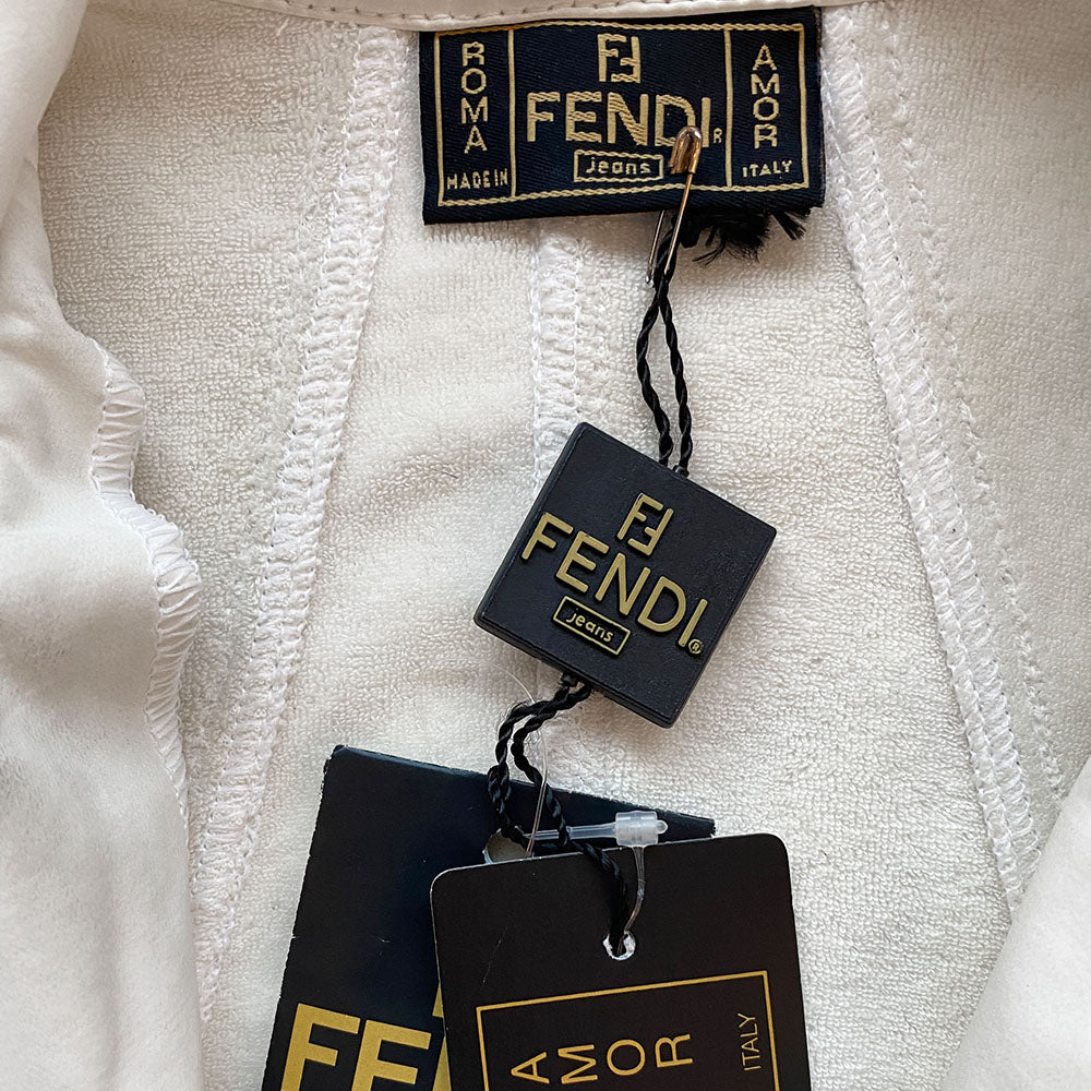 Fendi rubberized white with black piping exterior on terry cloth interior lining collared vest with silver-tone Fendi logo snap button front closure, black piping and Fendi Jeans logo ribbon detail at sides. 2 front zippered pockets with FF logo zipper pulls. Made in Italy