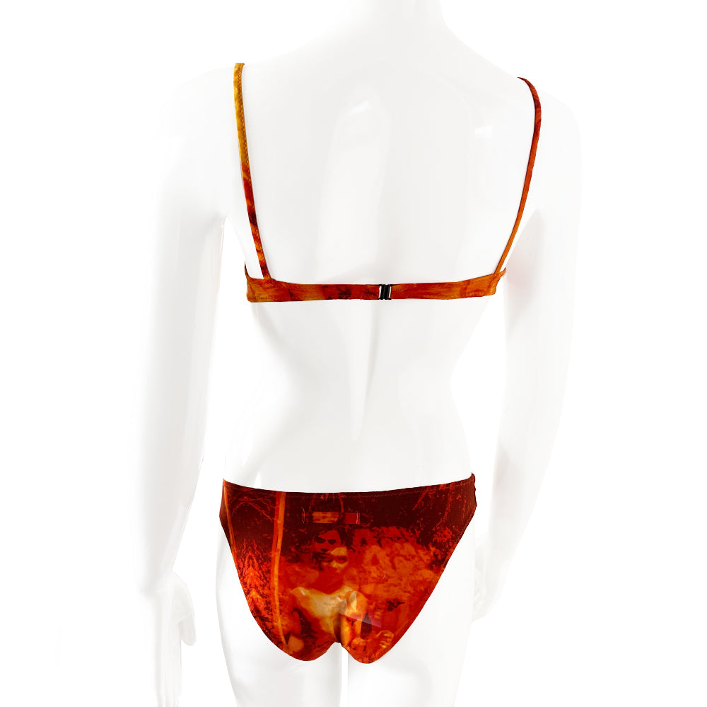 New Jean Paul Gaultier orange/black/gold color Hawaiian graphic print bikini from the Soleil collection. Top and mid-rise bottoms feature Hawaiian girl against tropical background. Soft unstructured bra with underwire cups, back clasp closure, contrast stretch straps. Partially lined Size: IT 42 Made in Italy