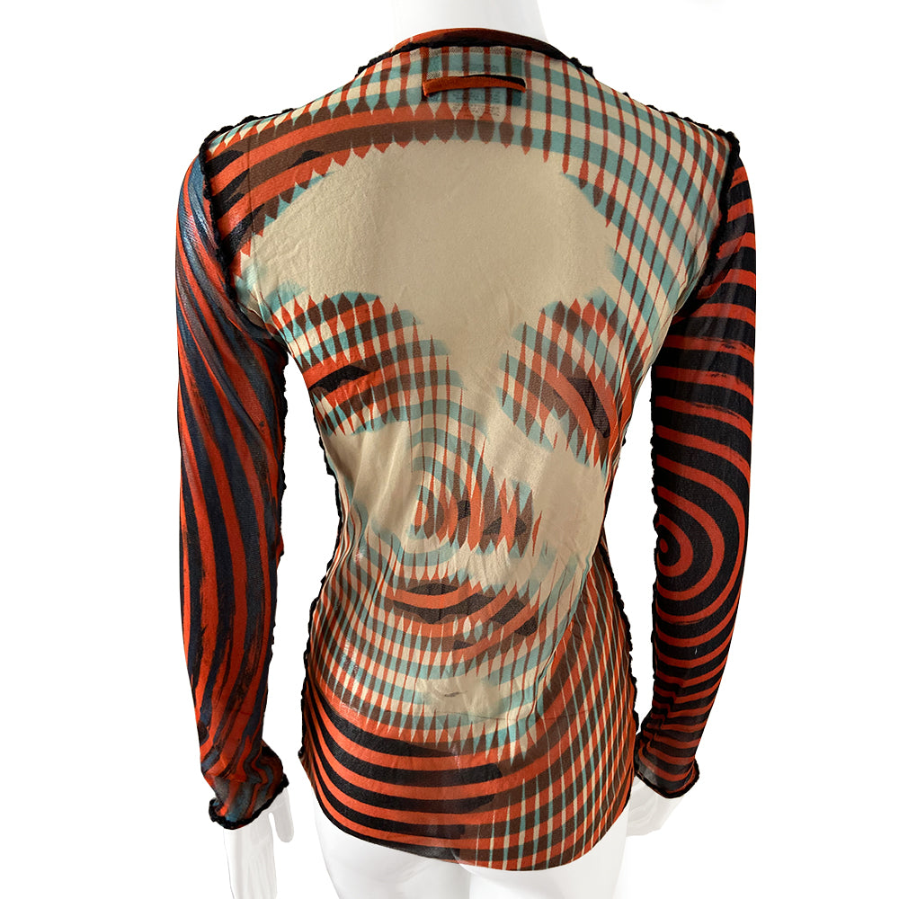 Jean Paul Gaultier Rare Optical Illusion red, black, blue on nude mesh cardigan, Maille Femme collection, early 2000’s. Printed stretch mesh with Marlene Dietrich on front and back. Red and black stripes at front and on sleeves. Snap button front closure, 2 lower front pockets with black boucle seam and pockets accent.