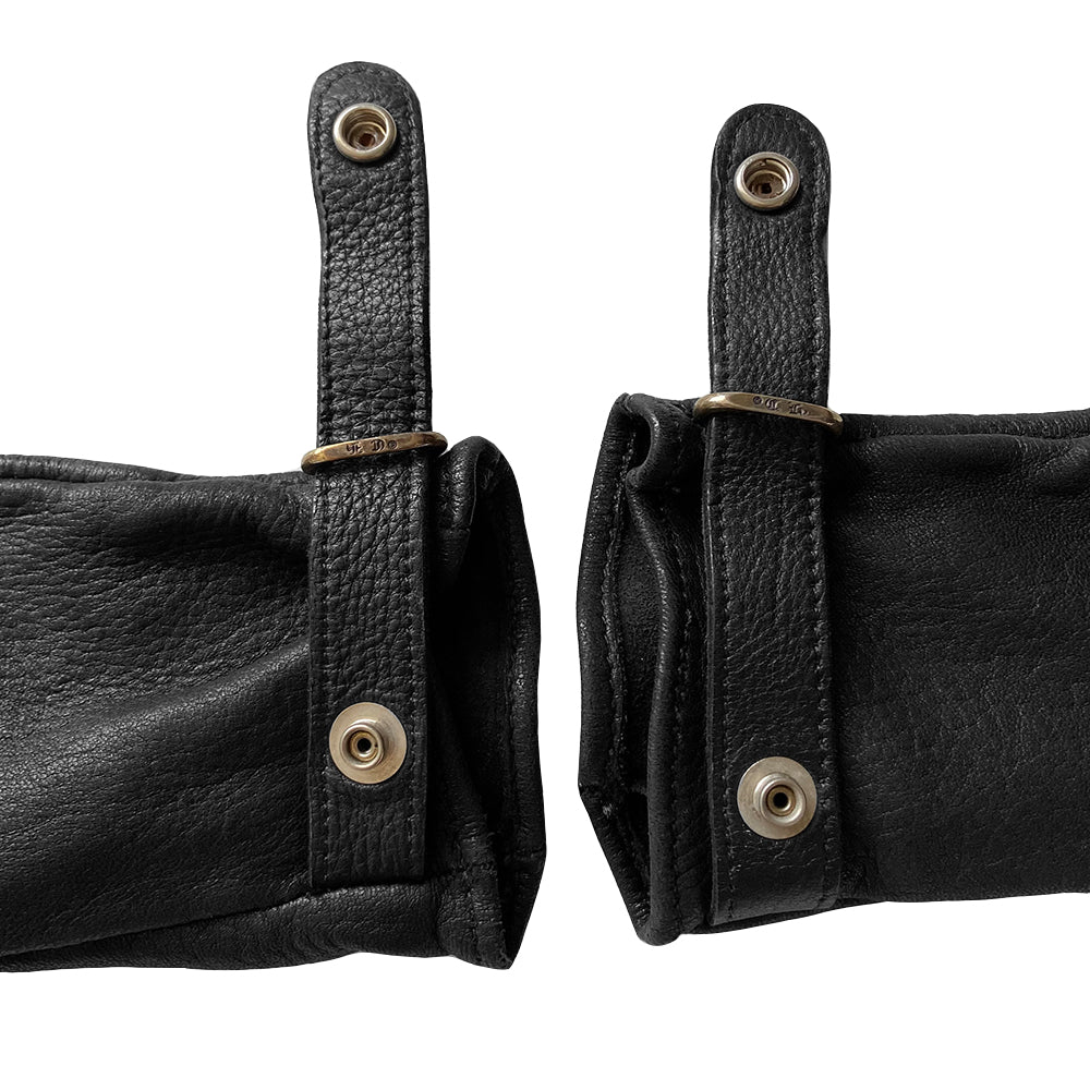 Chrome Hearts black size 7.5 leather gloves, circa mid 2000’s. Unlined with leather wrist strap and sterling silver logo snap button closure. Made in USA
