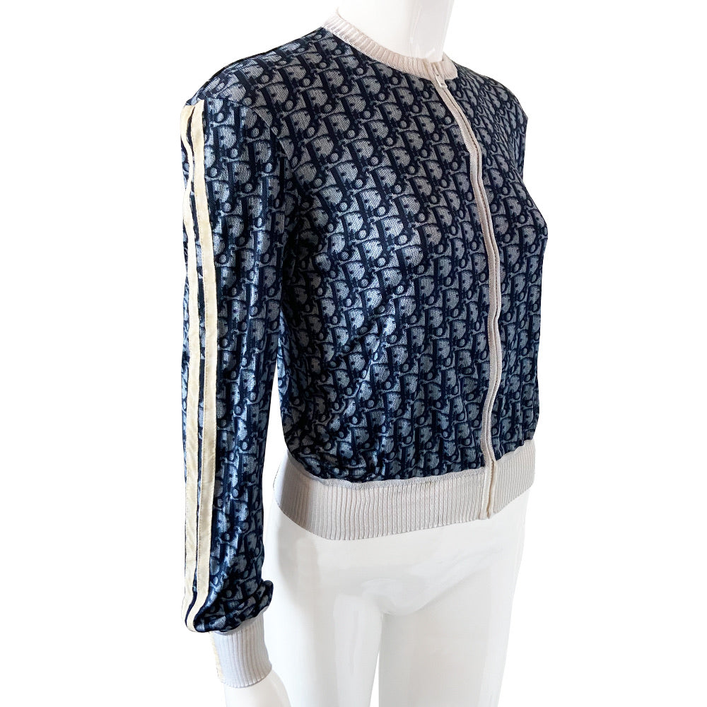 Christian Dior navy monogram on white zip jacket From 2002 by John Galliano for Dior. Long sleeved front zip Diorissimo print long sleeved with white accent ribbing at neckline and cuffs, 2 off-white stripes on each sleeve. Fabric: 100% Viscose Tag Size: FR 42. Made in France