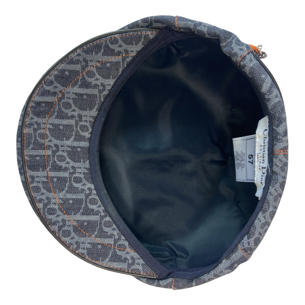 Christian Dior navy monogram flat cap by John Galliano for Dior, 2004 with orange contrast stitching, orange band, calf leather accent trim and orange rubber Dior logo hanging tag attached. Grosgrain interior ribbon and navy textile lining. Made in France