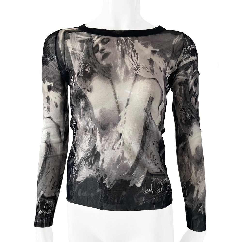 Jean Paul Gautier posing woman black and white long sleeve mesh top by Jean Paul Gaultier, JPG circa mid 90’s with posing woman graphic and Jean Paul Gaultier signature on front, back and sleeves Black banded scoop neck. Tage size: 40 Made in Japan