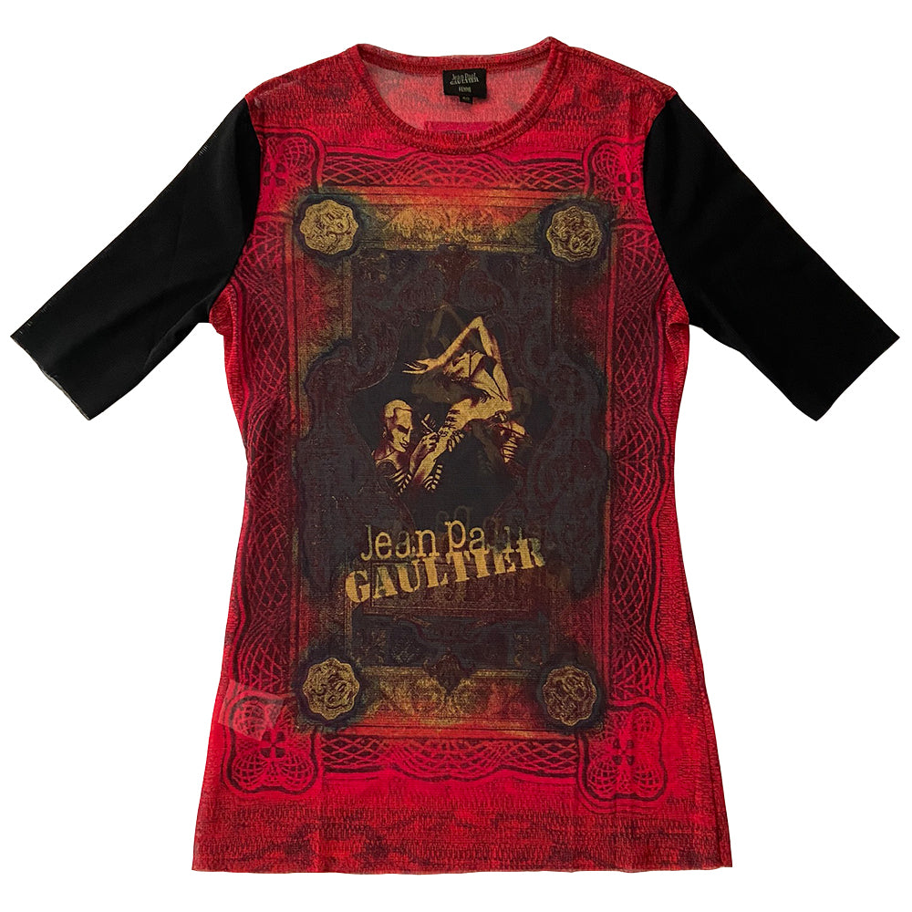 Jean Paul Gaultier tattoo artist 3/4 sleeve mesh top Jean Paul Gaultier Femme circa 1995 featuring Jean Paul Gaultier tattooing a woman’s arm on front and back. Tag size: 40 Main Colors: Red, black sleeves. Made in Japan