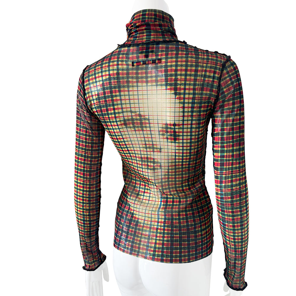Jean Paul Gaultier illusion print green, red, blue mesh turtleneck by Jean Paul Gaultier Femme, circa 2001 with all over multicolor check print long sleeves and Illusion print woman's face on front and back, boucle trim at neckline, seams and sleeve cuffs. Color: Green, red, blue, yellow. Made in Japan.