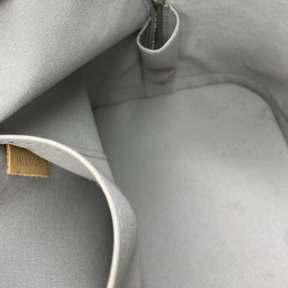 Louis Vuitton mirrored silver-tone monogram embossed vinyl Alma GM bag by Marc Jacobs for Louis Vuitton, 2008 with mirrored silver-tone leather dual handles, trim, bottom with tonal metal feet. Silver-tone top zipper with dual mirrored leather zipper pulls, grey textile interior with open slip and cell phone pocket. Made in France