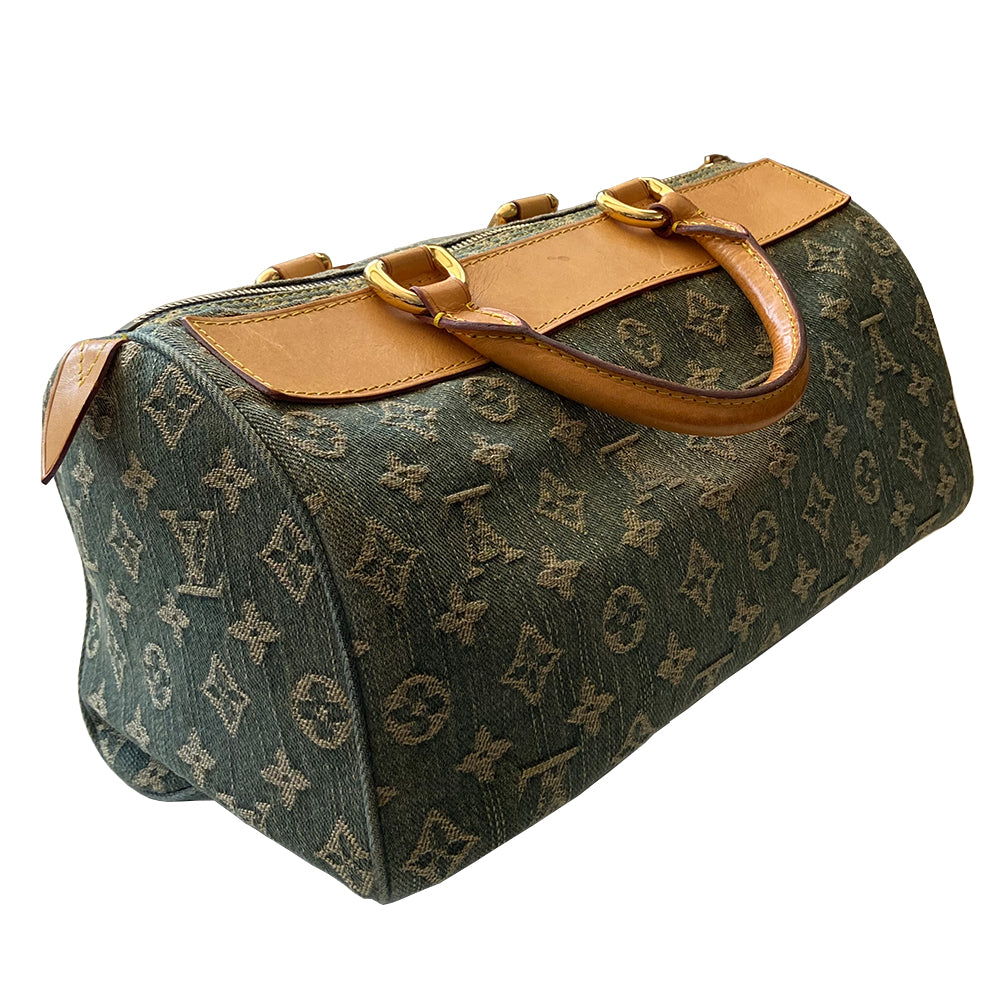 Louis Vuitton blue stonewashed monogram denim Neo Speedy Bag by Marc Jacobs for Louis Vuitton, 2005. 2 outer front pockets with gold-tone push lock closures and outer zip pocket. Vachetta leather trimmed with 2 rolled leather handles. Top zipper closure opens to gold/tan alcantara lining, one interior slip pocket. Made in France