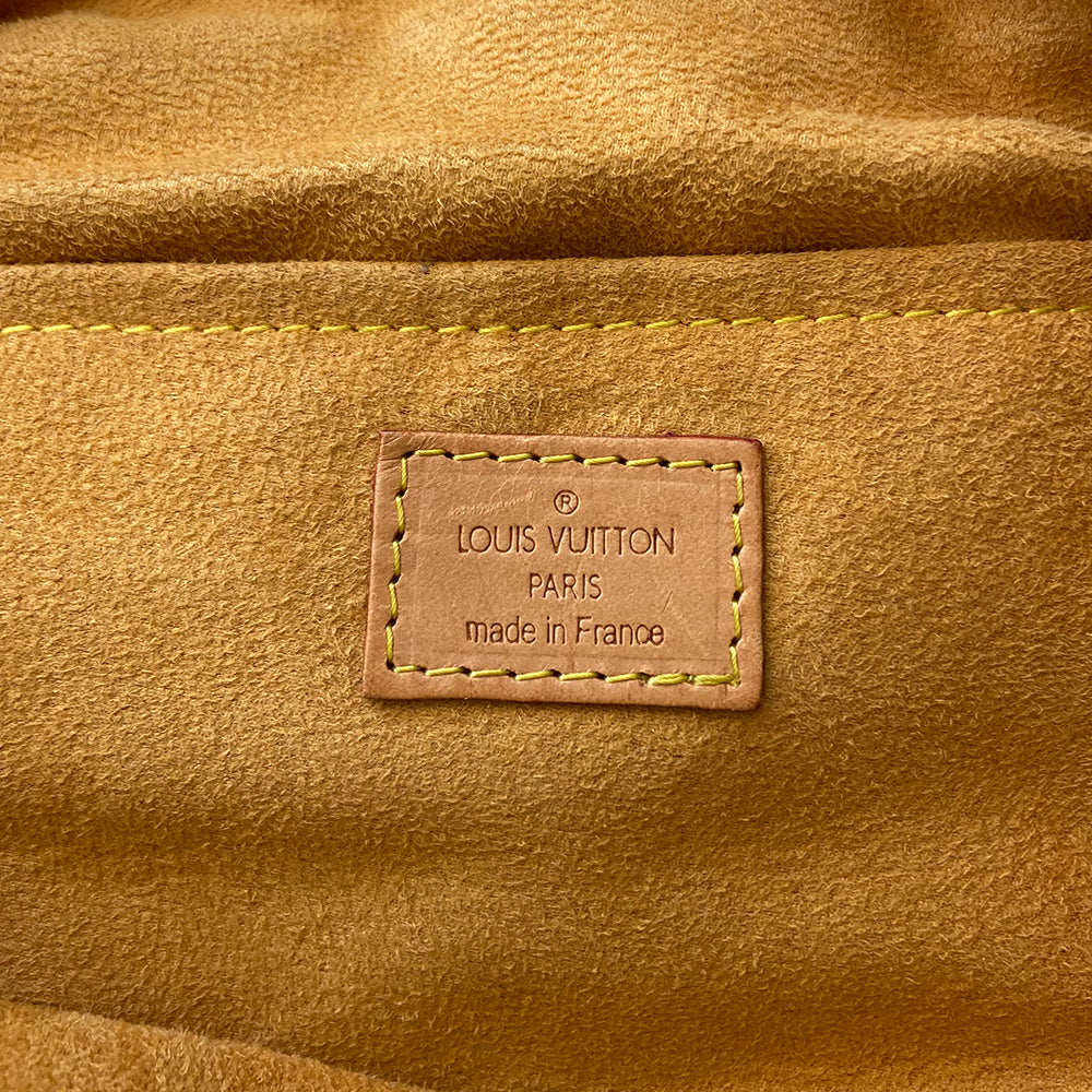 Louis Vuitton blue stonewashed monogram denim Neo Speedy Bag by Marc Jacobs for Louis Vuitton, 2005. 2 outer front pockets with gold-tone push lock closures and outer zip pocket. Vachetta leather trimmed with 2 rolled leather handles. Top zipper closure opens to gold/tan alcantara lining, one interior slip pocket. Made in France