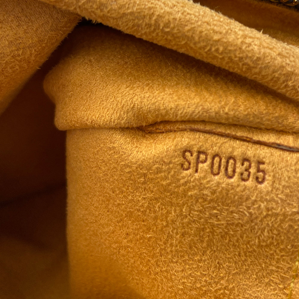 Louis Vuitton blue stonewashed monogram denim Neo Speedy Bag by Marc Jacobs for Louis Vuitton, 2005. 2 outer front pockets with gold-tone push lock closures and outer zip pocket. Vachetta leather trimmed with 2 rolled leather handles. Top zipper closure opens to gold/tan alcantara lining, one interior slip pocket. Made in France