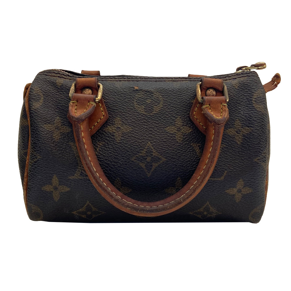 Louis Vuitton Monogram Nano Speedy bag from 1994 with vachetta leather rolled handles, piping and accent and gold-tone hardware. Top zip closure, canvas lining, interior date code is visible. Made in France