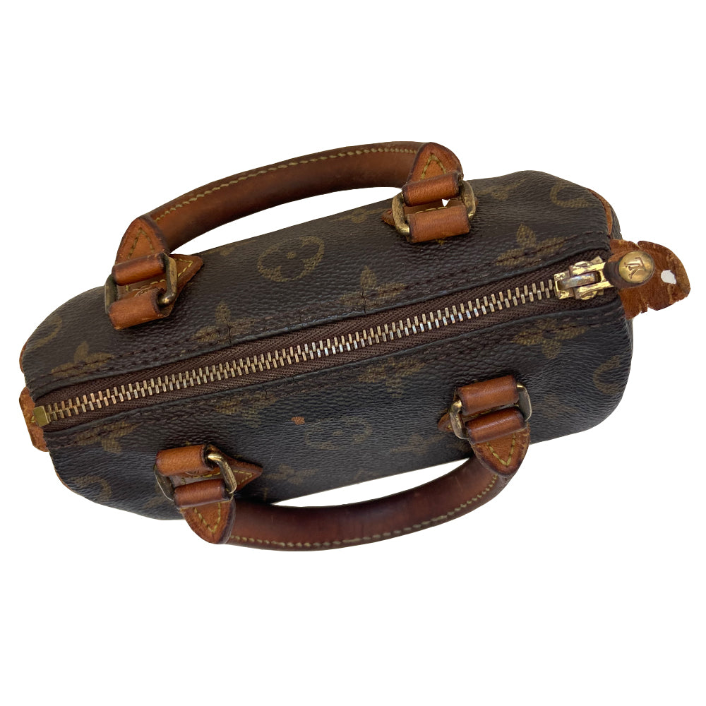 Louis Vuitton Monogram Nano Speedy bag from 1994 with vachetta leather rolled handles, piping and accent and gold-tone hardware. Top zip closure, canvas lining, interior date code is visible. Made in France