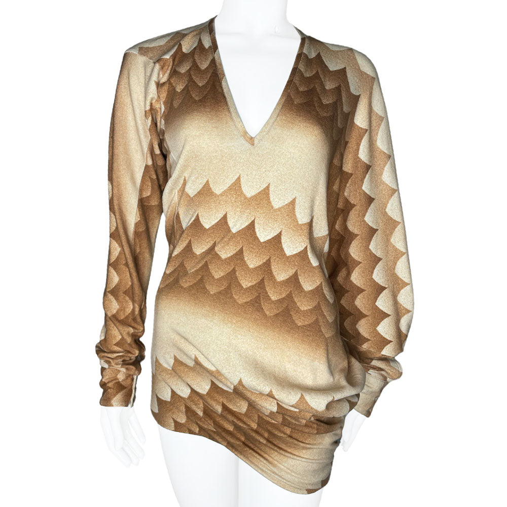 Long sleeve brown, beige and cream print V neck jersey dress by Alexander Mcqueen, circa 2010 with ruching at hips and uneven hemline. Asymmetric sleeves with three button detail at each cuff.