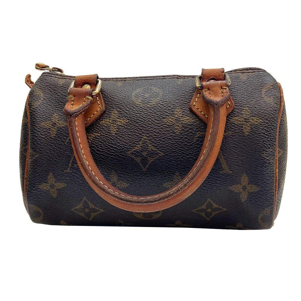 Louis Vuitton Monogram Nano Speedy bag from 1994 with vachetta leather rolled handles, piping and accent and gold-tone hardware. Top zip closure, canvas lining, interior date code is visible. Made in France