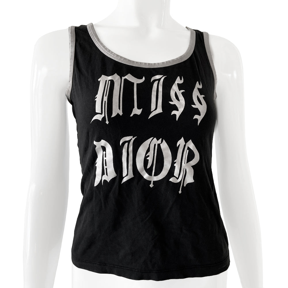 Christian Dior rare Gothic Script Tank circa 2002 by John Galliano for Dior Super soft stretch fabric with piping at neckline and arm holes. Color: Black with white script lettering and accent. Fabric: 95% Cotton, 5% Lycra Made in Italy Missing size tag Nape of Neck to Bottom Hem (in) 18.5" Chest approx (in) 16"