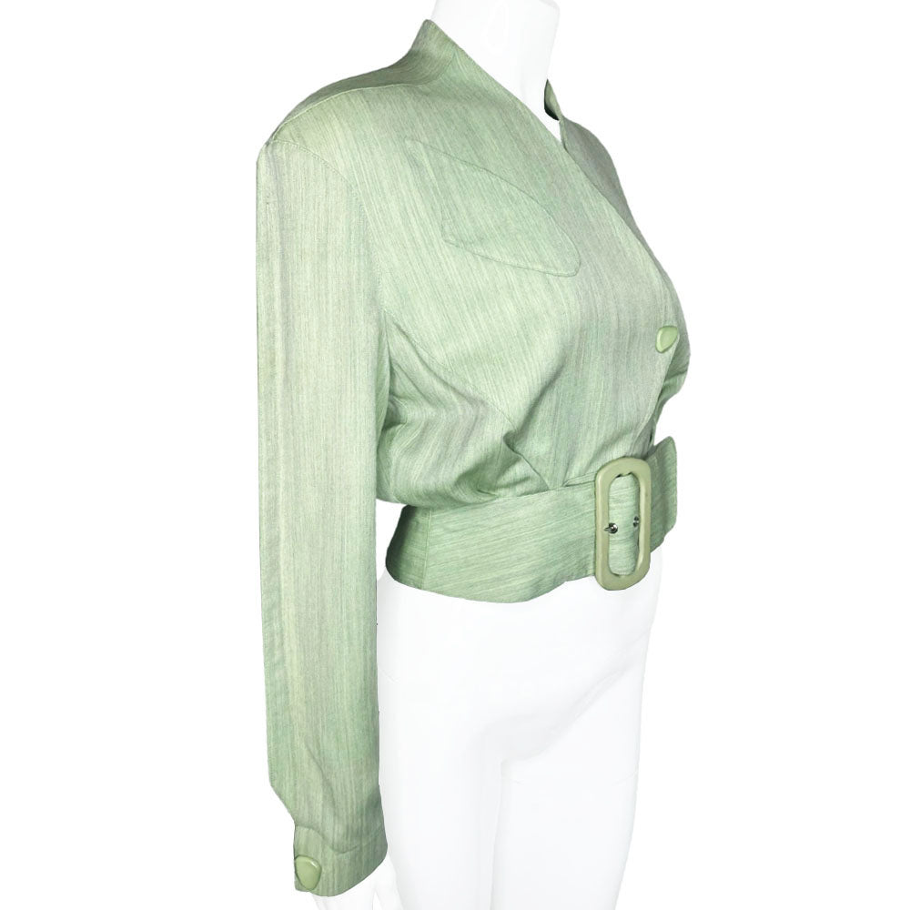 Thierry Mugler 1980's seafoam green wool jacket with angled front flap featuring the iconic Mugler wave, green acetate belt and triangle buttons. Three front snap closures, two at waist and one at chest, back pleats and blouson body. Made in France