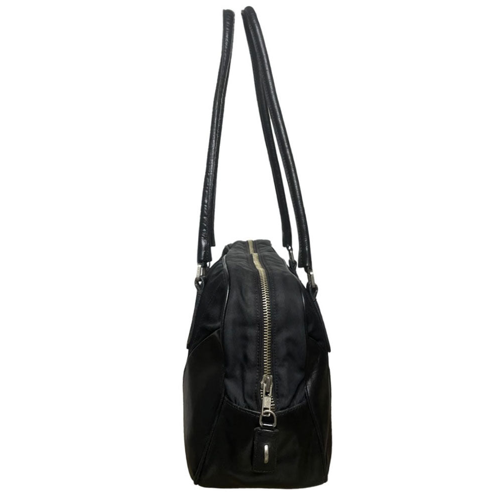 Prada tessuto Shoulder Bag Circa 2000's, black nylon bag with leather handles, front panels and piping, front logo plaque. Zip closure with silver-tone YKK zipper pull opens to black jacquard logo lining, one interior pocket. Made in Italy