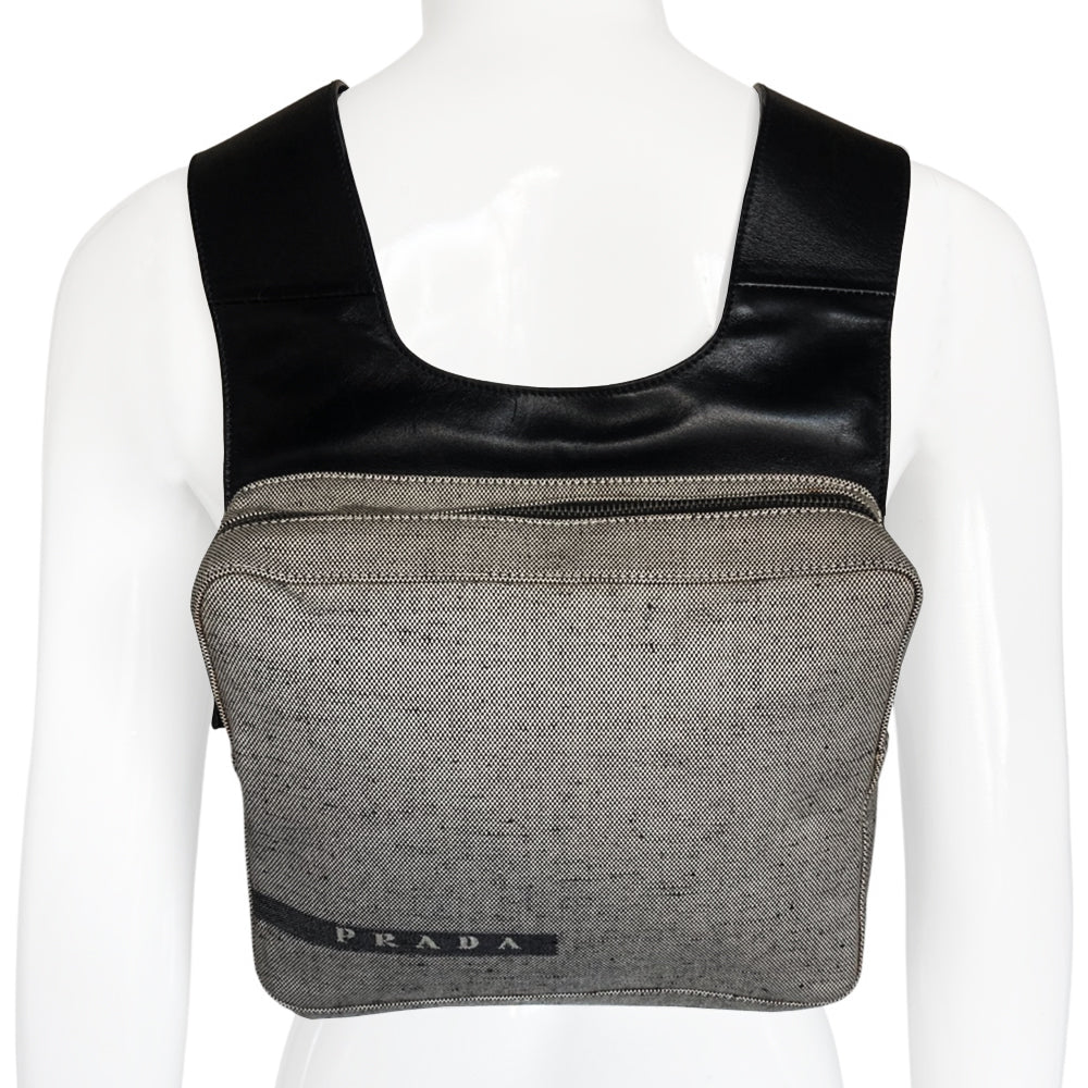 Prada spring 1999 RTW runway backpack in black and white tweed with black leather backing, adjustable leather harness straps, silver-tone hardware. Top zipper opens to jacquard logo textile lining with interior zip pocket. Made in Italy