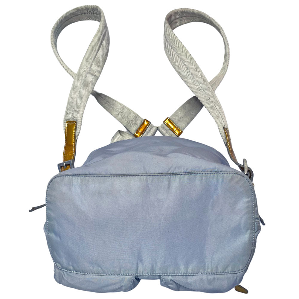 Prada powder blue nylon tessuto drawstring backpack circa 2011, magnetic closure flap with Prada logo plate, 2 zip outer front pockets, brown patent leather strap & accent, silver-tone Prada engraved buckle & drawstring grommets. Adjustable webbing & leather straps. Beige jacquard Prada logo textile lining with interior zip pocket. Made in Italy